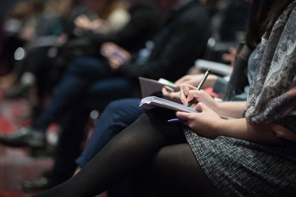 Lady taking notes at conference - Photo by The Climate Reality Project on Unsplash
