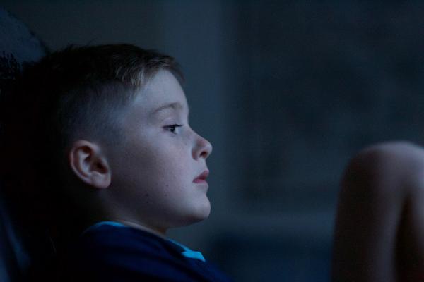 Sad boy in dark room - Photo by Luke Pennystan on Unsplash